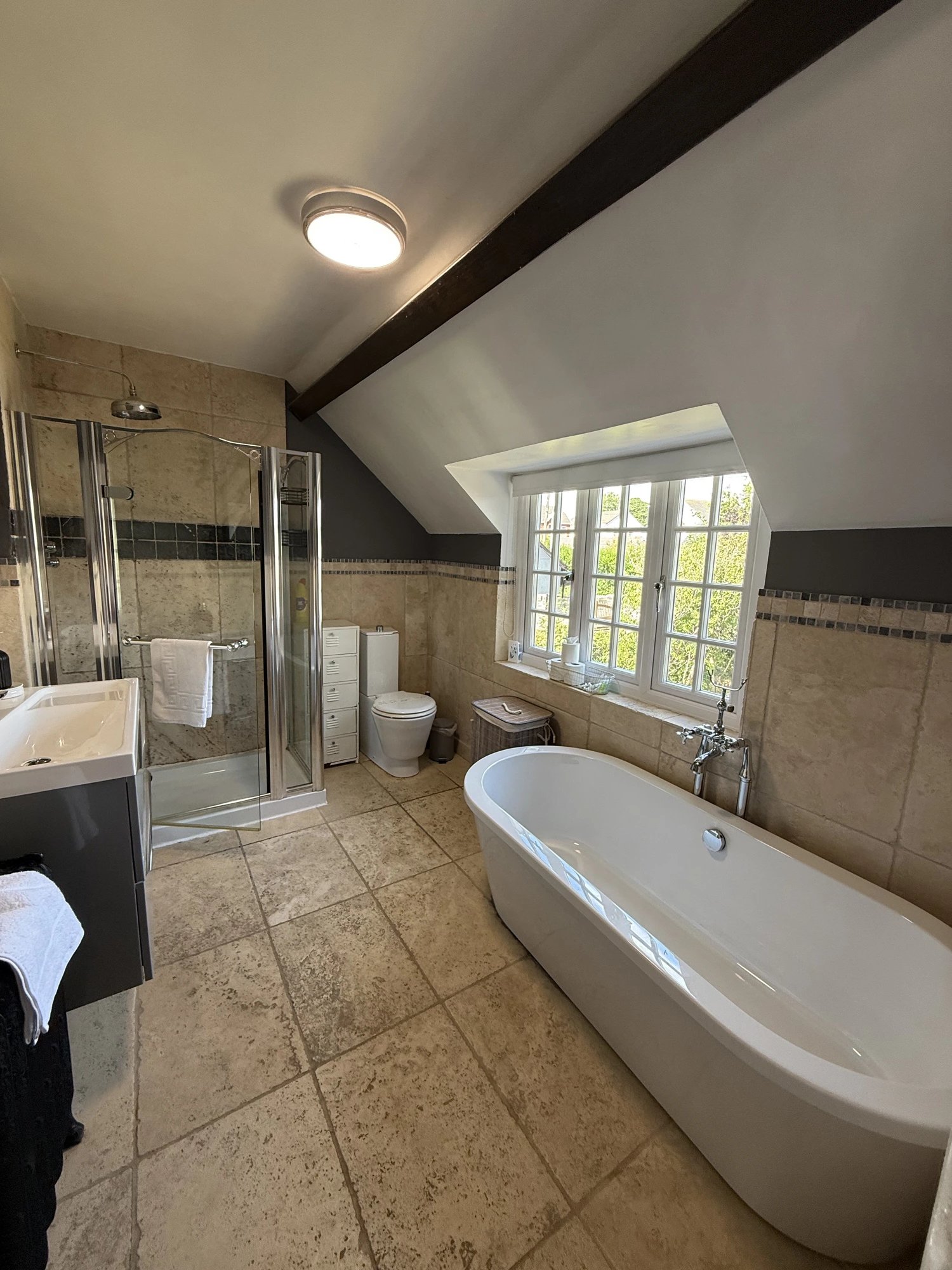 Immaculate bathroom with freestanding bath and walk-in shower
